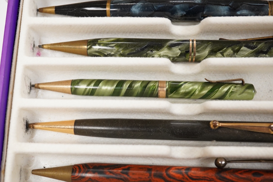 A collection of vintage pencils including an early enamel example